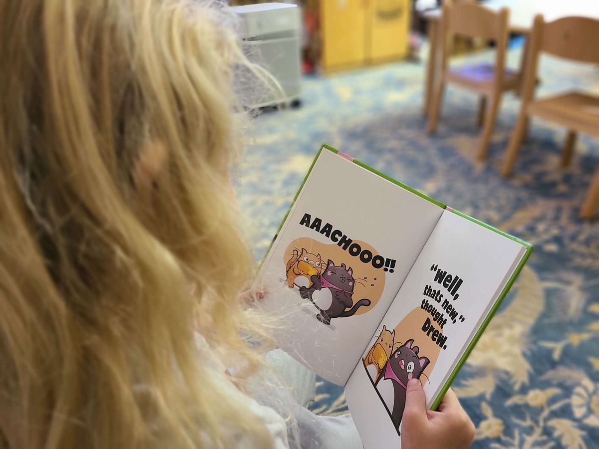 A child reading a Frensville book